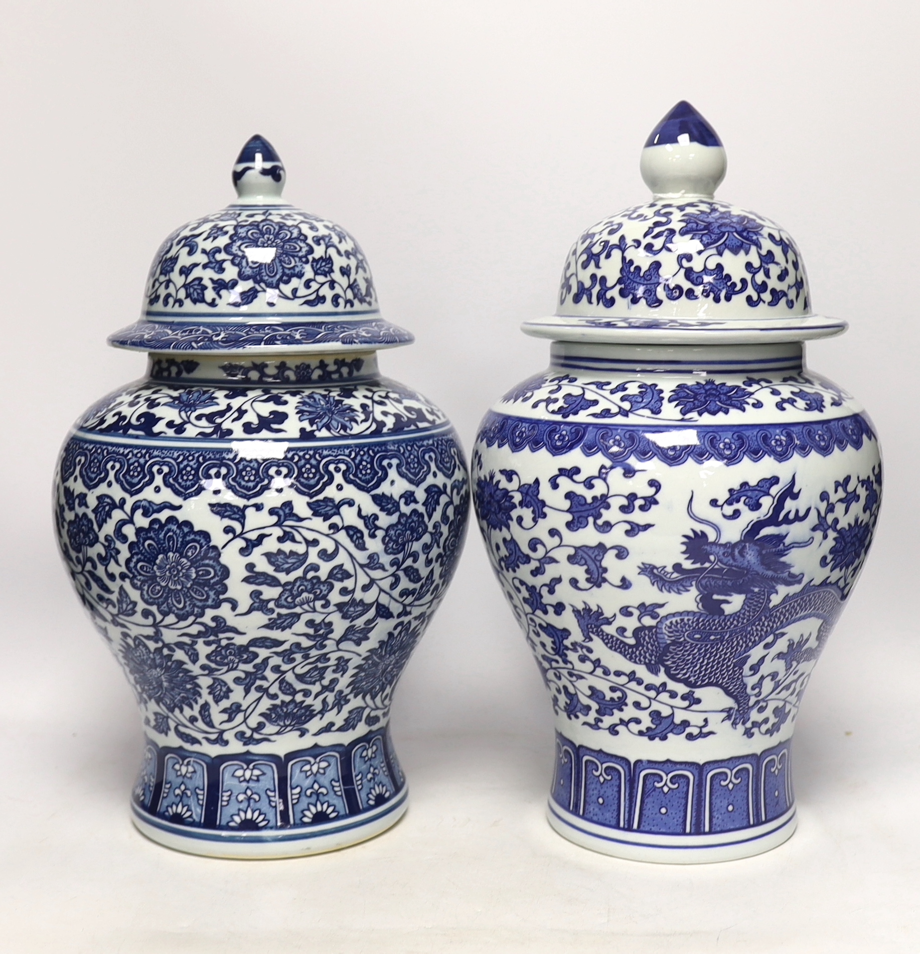 Two Chinese blue and white vases and covers, 38cm high